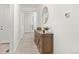 Bright entryway with wood flooring, a decorative cabinet with mirror, and a view of the front door at 24447 E Ada Ave, Aurora, CO 80018