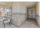 Covered front porch featuring stone accents and inviting entry way at 24447 E Ada Ave, Aurora, CO 80018