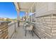 Cozy front porch with chairs and a table, perfect for relaxing and enjoying the neighborhood views at 24447 E Ada Ave, Aurora, CO 80018