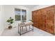 Sunlit home office with a modern desk, decorative wood paneling and a large window offering outdoor views at 24447 E Ada Ave, Aurora, CO 80018