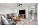 Inviting living room with a large TV, comfortable seating, and a bright atmosphere at 24447 E Ada Ave, Aurora, CO 80018