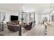 Spacious living room with hardwood floors, large windows, and comfortable brown leather furniture at 24447 E Ada Ave, Aurora, CO 80018
