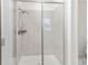 Tiled shower with glass door and shower head in bright, updated bathroom at 24447 E Ada Ave, Aurora, CO 80018