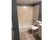 This bathroom features a tile floor, bathtub, standard toilet, and gray paint at 14493 E Jewell Ave # 102, Aurora, CO 80012