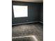Bedroom with neutral-colored carpet, a bright window, and freshly painted walls at 14493 E Jewell Ave # 102, Aurora, CO 80012