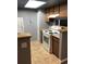 Cozy kitchen with wood cabinets, white appliances, and ample counter space at 14493 E Jewell Ave # 102, Aurora, CO 80012