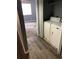 Convenient laundry closet with a stacked washer and dryer adjacent to bedroom at 14493 E Jewell Ave # 102, Aurora, CO 80012