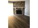 Living room with stone fireplace, wood-look floors, and a neutral color scheme at 14493 E Jewell Ave # 102, Aurora, CO 80012