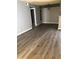 Open living room and dining area with wood-look floors and neutral gray walls at 14493 E Jewell Ave # 102, Aurora, CO 80012