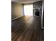 Bright living room with wood-look floors, stone fireplace, and sliding glass doors at 14493 E Jewell Ave # 102, Aurora, CO 80012