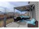 Covered deck with comfortable seating and a grill at 3934 Alamosa Ct, Brighton, CO 80601