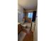 Bathroom with brown tile floor, toilet, and tub/shower combo at 1810 W Asbury Ave, Denver, CO 80223