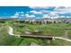 Scenic aerial view of a neighborhood with lush green spaces, walking trails, and a picturesque bridge at 4025 Trail Stone Cir, Castle Rock, CO 80108