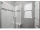 Modern bathroom featuring glass shower with tiled walls and a mosaic accent stripe detail at 4025 Trail Stone Cir, Castle Rock, CO 80108