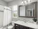 Bathroom with a vanity, a large mirror, a shower with a curtain, and neutral decor at 4025 Trail Stone Cir, Castle Rock, CO 80108