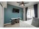 Charming bedroom with an accent wall, desk, and a full-sized bed, creating a functional and relaxing space at 4025 Trail Stone Cir, Castle Rock, CO 80108