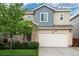 Inviting two-story home featuring a two-car garage, stone accents, and a well-manicured front lawn at 4025 Trail Stone Cir, Castle Rock, CO 80108