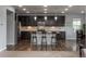 Modern kitchen with stainless steel appliances, a granite island, and bar seating at 4025 Trail Stone Cir, Castle Rock, CO 80108