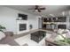 Inviting living room with a fireplace, ceiling fan, and open layout to the kitchen area at 4025 Trail Stone Cir, Castle Rock, CO 80108