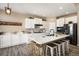 Modern kitchen features white cabinets, quartz countertops and breakfast bar at 2640 Cache Creek Ct, Castle Rock, CO 80108