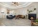 Cozy living room with fireplace, comfortable seating, and a neutral color palette at 2640 Cache Creek Ct, Castle Rock, CO 80108