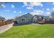 Spacious backyard with well-maintained lawn, wood deck, and rock garden, surrounded by privacy fence at 765 Freestone St, Brighton, CO 80603