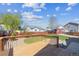 Large backyard with a wooden deck, mature trees, shed and play area, perfect for outdoor entertaining at 765 Freestone St, Brighton, CO 80603