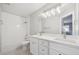 Bathroom features double sinks, vanity with drawers, tile floor, subway tile shower, and modern lighting at 765 Freestone St, Brighton, CO 80603
