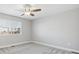 Bedroom features neutral walls, carpet, ceiling fan with light, and a large window with blinds for natural light at 765 Freestone St, Brighton, CO 80603