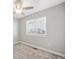 Bedroom features neutral walls, carpet, ceiling fan with light, and a large window with blinds for natural light at 765 Freestone St, Brighton, CO 80603