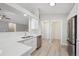 Modern kitchen with a stainless steel dishwasher, white cabinets, and quartz countertops at 765 Freestone St, Brighton, CO 80603