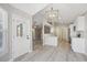 Inviting living space with hardwood flooring, modern light fixture, and an open layout at 765 Freestone St, Brighton, CO 80603
