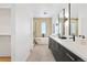Luxurious bathroom featuring a soaking tub, glass shower, and double vanity with modern fixtures at 16132 W 14Th Ave, Golden, CO 80401