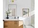 Stylish powder room featuring modern vanity with framed art and picture window at 16132 W 14Th Ave, Golden, CO 80401