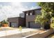 Beautiful exterior view of the modern home showcasing clean lines and large garage doors at 16132 W 14Th Ave, Golden, CO 80401