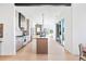 Open-concept interior view showcasing the kitchen and living room with modern design and abundant natural light at 16132 W 14Th Ave, Golden, CO 80401