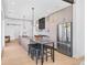 Modern kitchen featuring stainless steel appliances, a kitchen island with bar seating, and sleek, contemporary lighting at 16132 W 14Th Ave, Golden, CO 80401