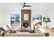 Bright living room with modern furnishings, a brick fireplace, and expansive windows showcasing the outdoor scenery at 16132 W 14Th Ave, Golden, CO 80401