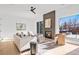 Bright living room with modern decor, fireplace, and large windows offering natural light and outdoor views at 16132 W 14Th Ave, Golden, CO 80401
