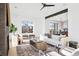 Open-concept living room with modern furniture, a fireplace, and large windows offering a bright and airy atmosphere at 16132 W 14Th Ave, Golden, CO 80401
