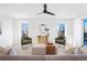 Bright living room with a modern ceiling fan, stylish decor, and scenic views from the windows at 16132 W 14Th Ave, Golden, CO 80401