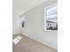 Carpeted bedroom with two windows providing natural light and outdoor views at 1306 Sienna Peak Cir, Erie, CO 80516