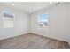Bright bedroom with wood flooring and large windows offering plenty of natural light at 1306 Sienna Peak Cir, Erie, CO 80516