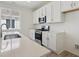 Bright kitchen features stainless steel appliances, white cabinets, and sleek countertops at 1306 Sienna Peak Cir, Erie, CO 80516