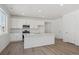 Bright kitchen with white cabinets, stainless steel appliances, and center island with sink at 1306 Sienna Peak Cir, Erie, CO 80516