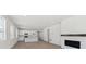 Spacious open-concept with kitchen, modern fireplace, and wood floors throughout at 1306 Sienna Peak Cir, Erie, CO 80516