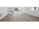 Spacious living room with wood flooring, modern fireplace, and sliding glass doors for natural light at 1306 Sienna Peak Cir, Erie, CO 80516