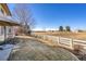 Expansive backyard featuring lush grass, mature trees, and a white fence, perfect for outdoor relaxation and recreation at 4405 Fairway Ln, Broomfield, CO 80023