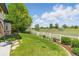 Expansive backyard with lush green grass, white fence, and mature trees offering stunning views, privacy and serenity at 4405 Fairway Ln, Broomfield, CO 80023