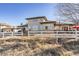 Spacious backyard featuring a white fence, mature trees, and views of the surrounding landscape, offering privacy at 4405 Fairway Ln, Broomfield, CO 80023